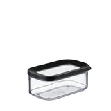 A clear plastic rectangular food storage container with a black lid, shown on a plain white background.